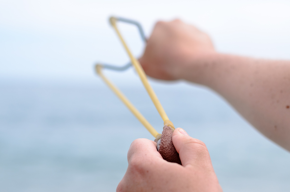 Man Hand Stretching Bands of his Stone Shooter